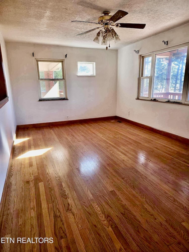 spare room featuring ceiling fan, a textured ceiling, and hardwood / wood-style flooring