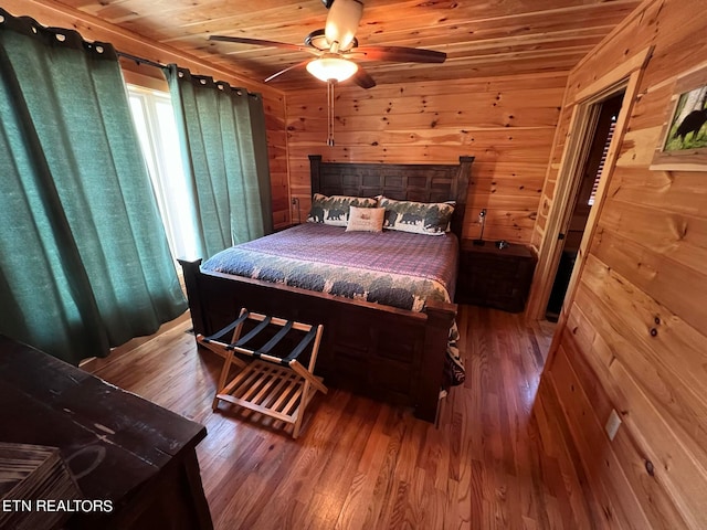 bedroom with wood ceiling, hardwood / wood-style flooring, and wooden walls