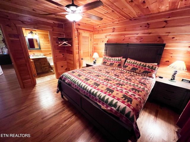 bedroom featuring wood ceiling, wood walls, hardwood / wood-style floors, and ceiling fan