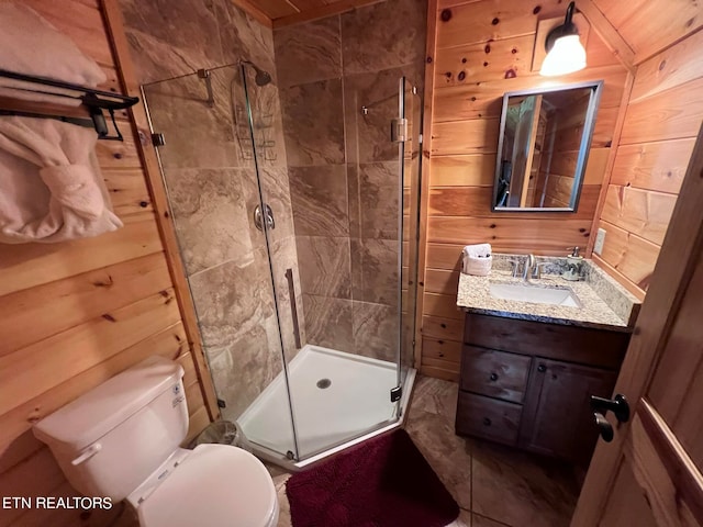 bathroom featuring wood walls, an enclosed shower, toilet, and large vanity