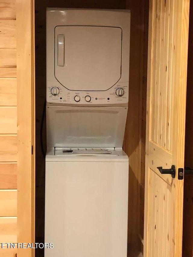 laundry room with stacked washer / drying machine