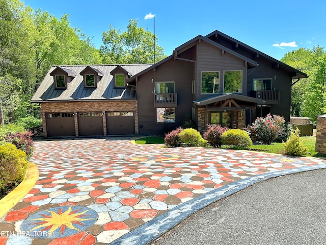 view of front of home with a balcony and a garage