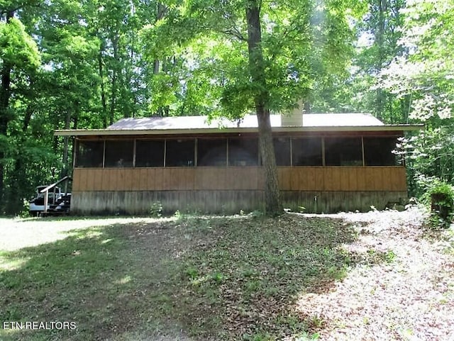 view of side of property with a sunroom