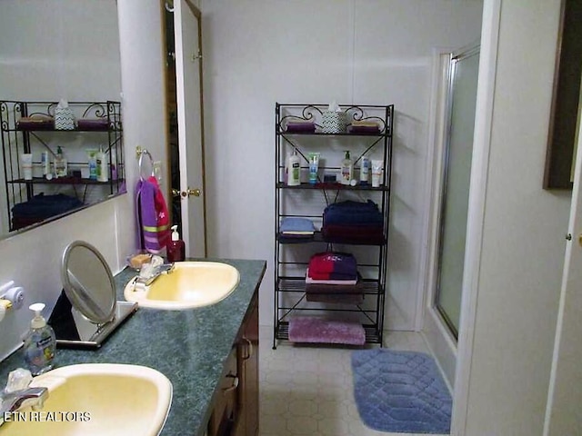 bathroom featuring large vanity, tile floors, and double sink