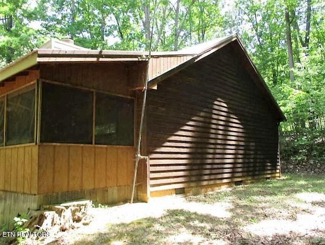 view of property exterior featuring a sunroom