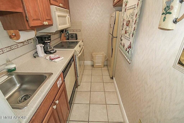 kitchen with sink, white appliances, light tile flooring, and backsplash