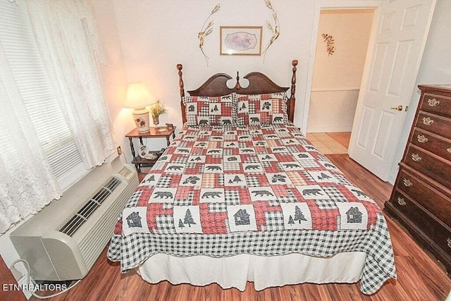 bedroom with hardwood / wood-style floors