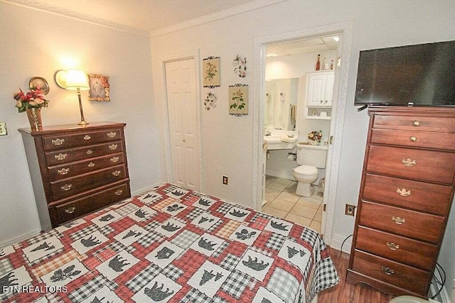 tiled bedroom featuring ensuite bath