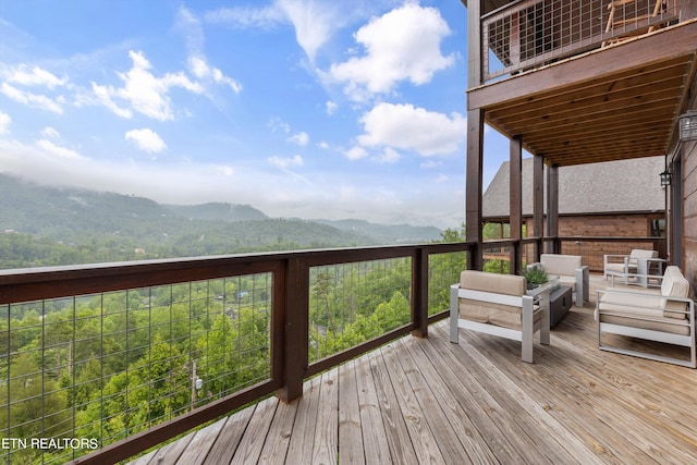 wooden deck with a mountain view