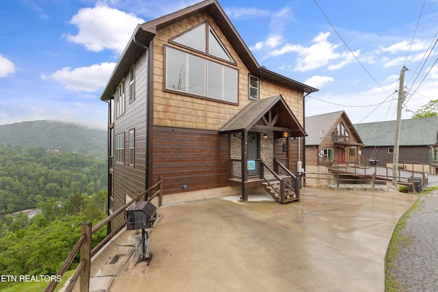 back of property with a mountain view