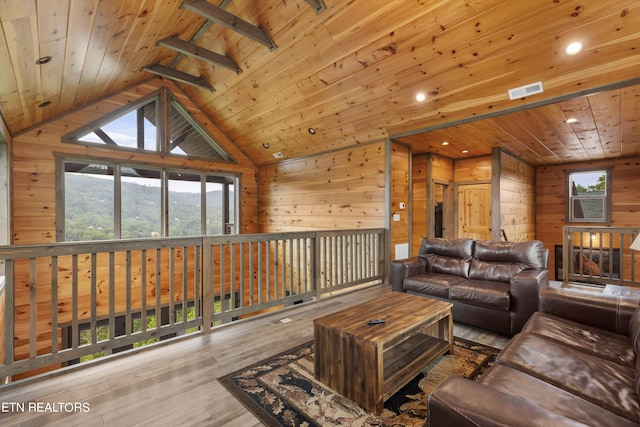 living room featuring light wood-type flooring and wood ceiling