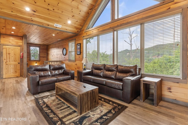 living room featuring plenty of natural light, light hardwood / wood-style floors, wood walls, wooden ceiling, and lofted ceiling