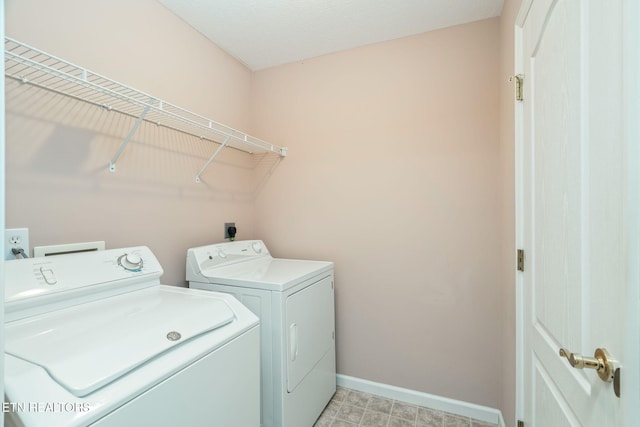laundry room featuring baseboards, independent washer and dryer, and laundry area