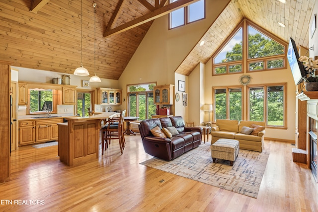 living room featuring a high end fireplace, light hardwood / wood-style floors, beam ceiling, wood ceiling, and high vaulted ceiling