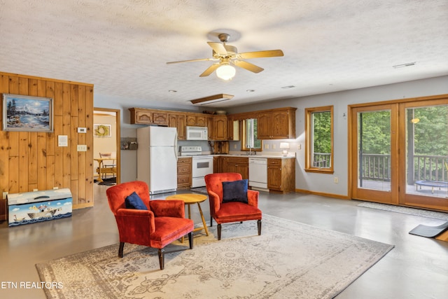 living room with sink, a textured ceiling, and ceiling fan