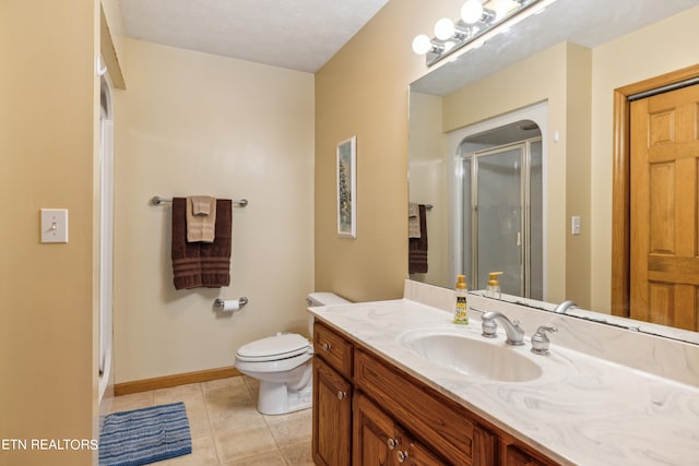 bathroom featuring a textured ceiling, toilet, tile floors, and large vanity