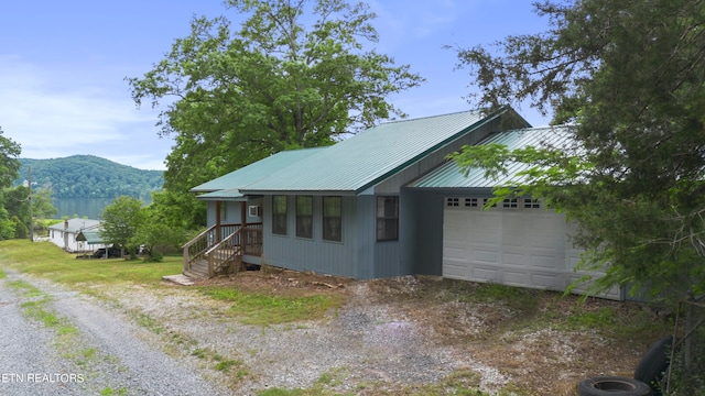 view of side of property featuring a garage and a mountain view