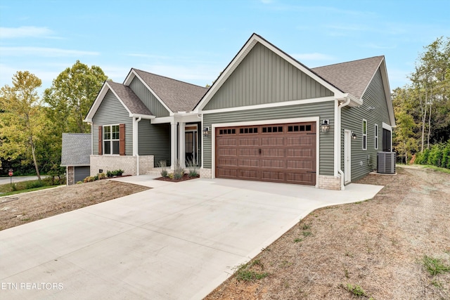 craftsman house featuring a garage and central AC unit