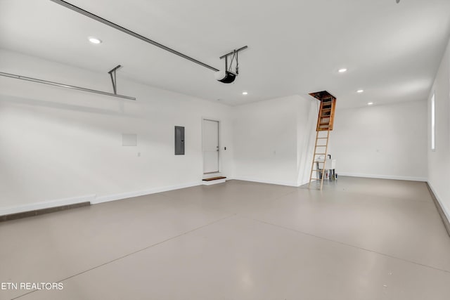 garage featuring electric panel and a garage door opener