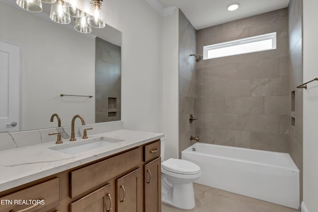 full bathroom featuring tile patterned flooring, toilet, tiled shower / bath combo, and vanity