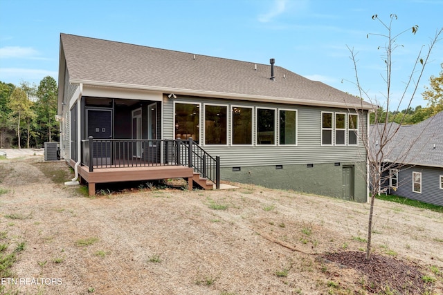 back of house with a sunroom, cooling unit, and a wooden deck