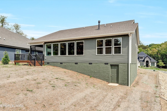 back of property with a wooden deck