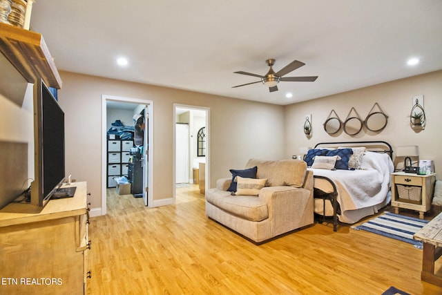 bedroom with a spacious closet, ceiling fan, wood-type flooring, a closet, and connected bathroom