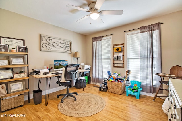 office space with light hardwood / wood-style flooring and ceiling fan