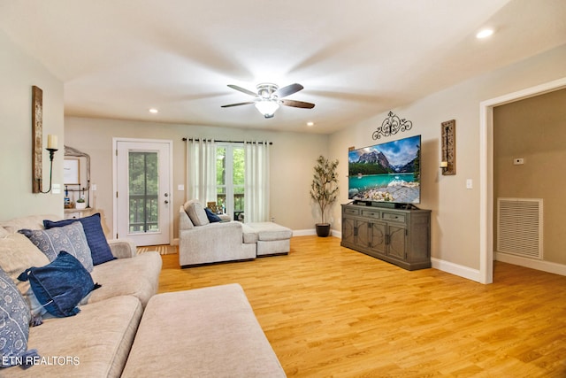 living room with ceiling fan and light hardwood / wood-style floors