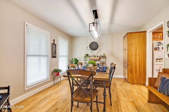 dining room with a healthy amount of sunlight and light wood-type flooring