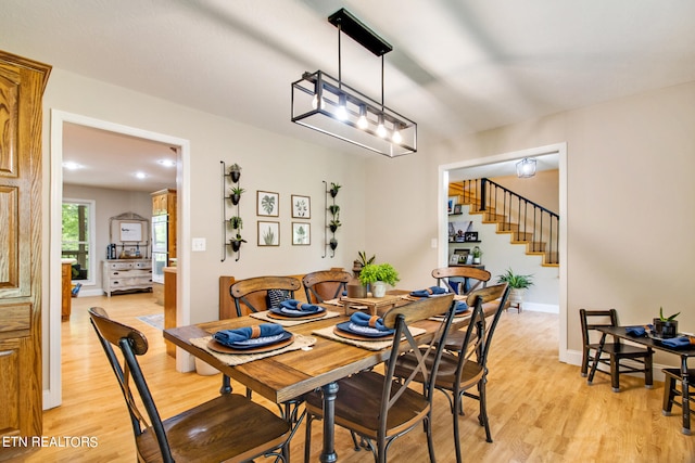 dining space with light hardwood / wood-style floors