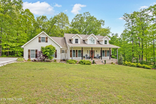 cape cod house with covered porch and a front yard