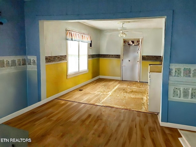 unfurnished dining area featuring ceiling fan and hardwood / wood-style floors