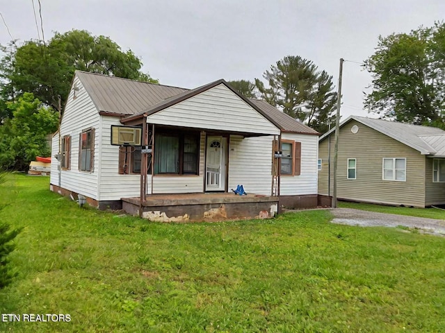 bungalow with a front lawn and a porch