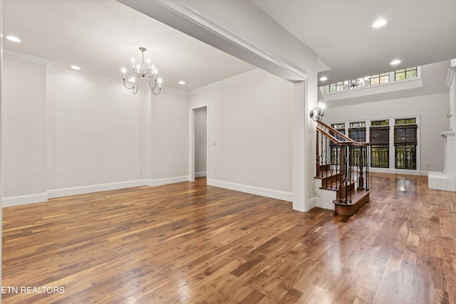 interior space with wood-type flooring, crown molding, and a notable chandelier