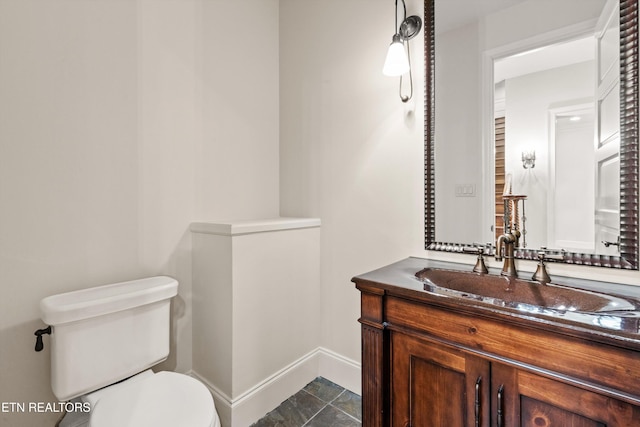 bathroom featuring tile patterned flooring, vanity, and toilet