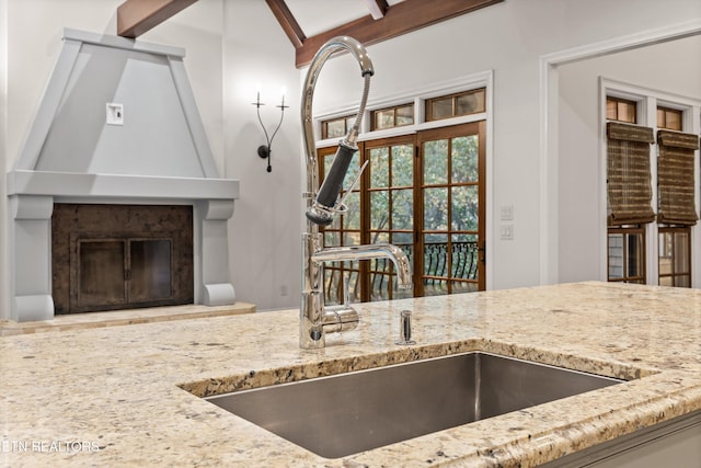 kitchen with a fireplace and beam ceiling