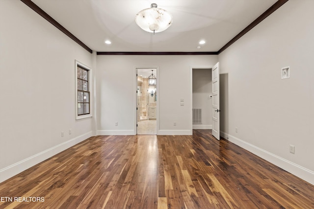 interior space featuring dark wood-type flooring and crown molding