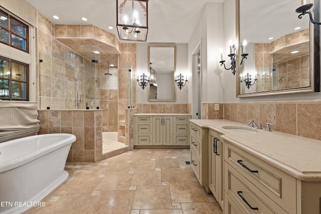 bathroom with tile walls, vanity, and plus walk in shower