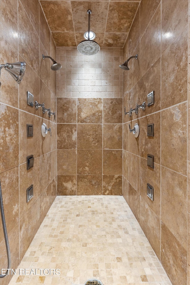 bathroom with a tile shower