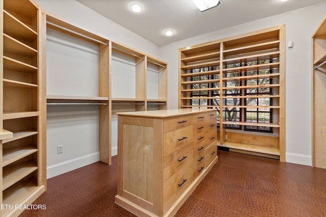 walk in closet featuring dark colored carpet