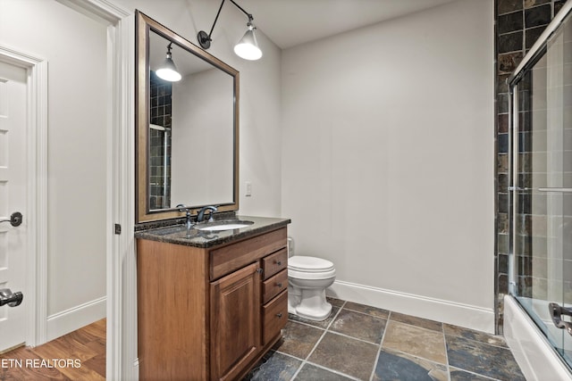 full bathroom featuring enclosed tub / shower combo, vanity, toilet, and hardwood / wood-style flooring