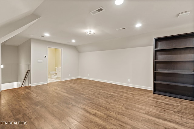 interior space with light hardwood / wood-style floors and vaulted ceiling