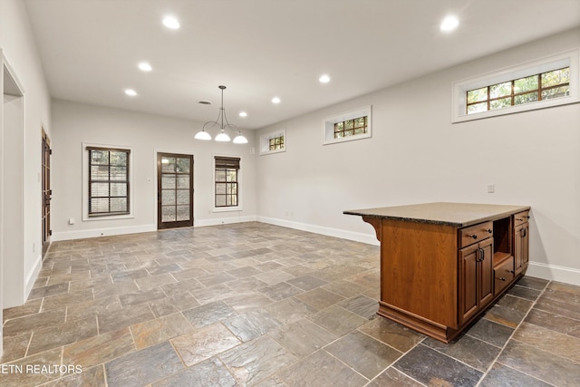 interior space featuring pendant lighting and an inviting chandelier