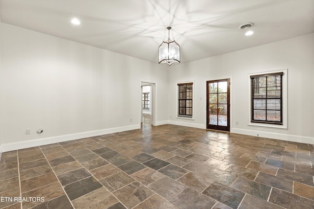 spare room with an inviting chandelier