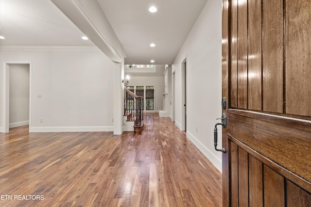 entryway featuring ornamental molding and hardwood / wood-style flooring