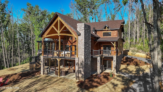 exterior space featuring outdoor lounge area, a balcony, and a patio