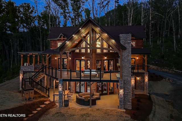 rear view of house featuring outdoor lounge area and a patio