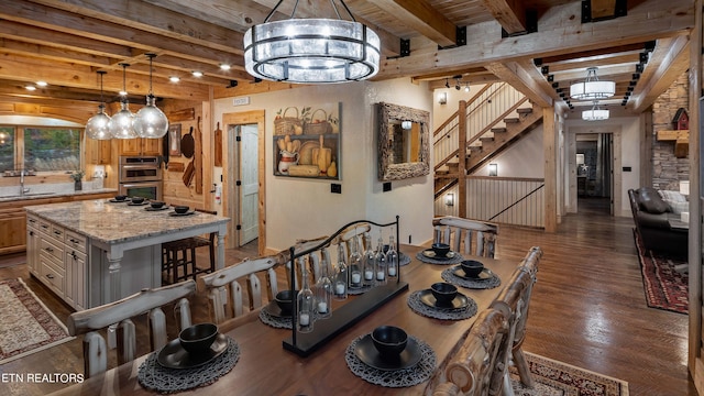 dining space with an inviting chandelier, wooden ceiling, sink, dark hardwood / wood-style flooring, and beamed ceiling