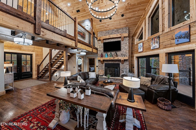 living room with high vaulted ceiling, dark hardwood / wood-style flooring, french doors, and wooden walls